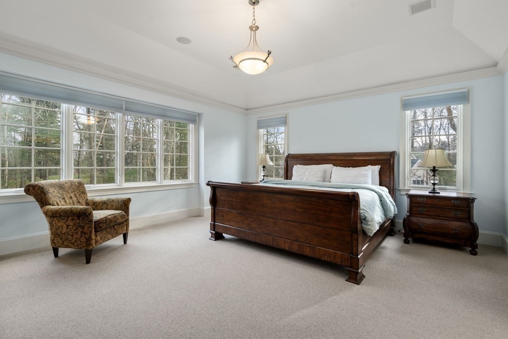 7 Donnelly Drive Dover, MA 02030 - Photo 17 of 29 a bedroom with a bed and a couch next to a window
