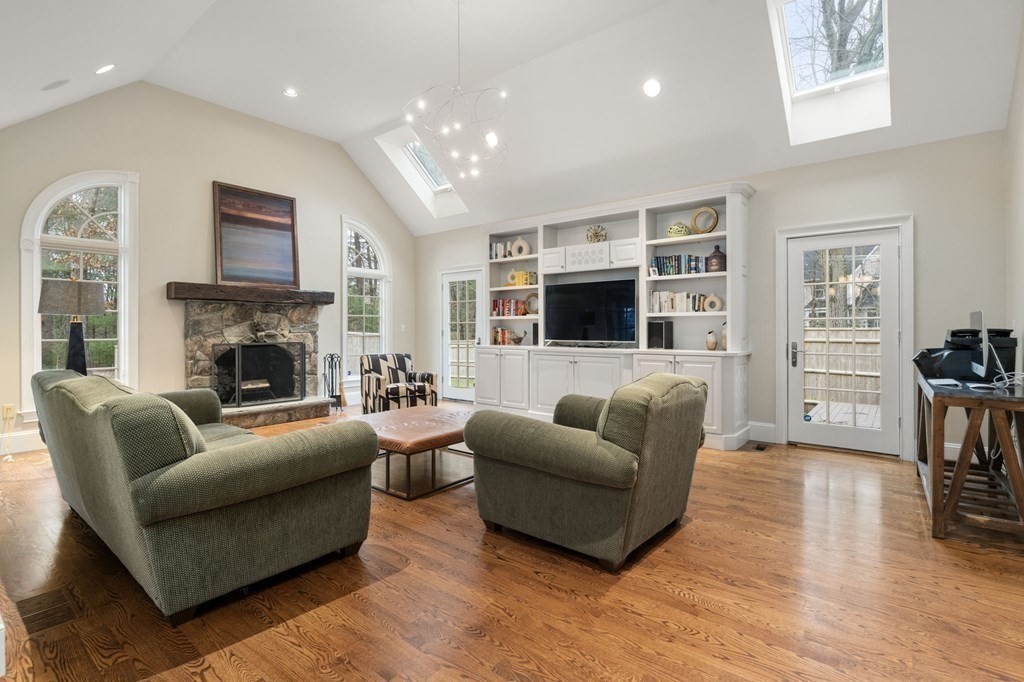 7 Donnelly Drive Dover, MA 02030 - Photo 9 of 29 a living room with furniture a flat screen tv and a fireplace