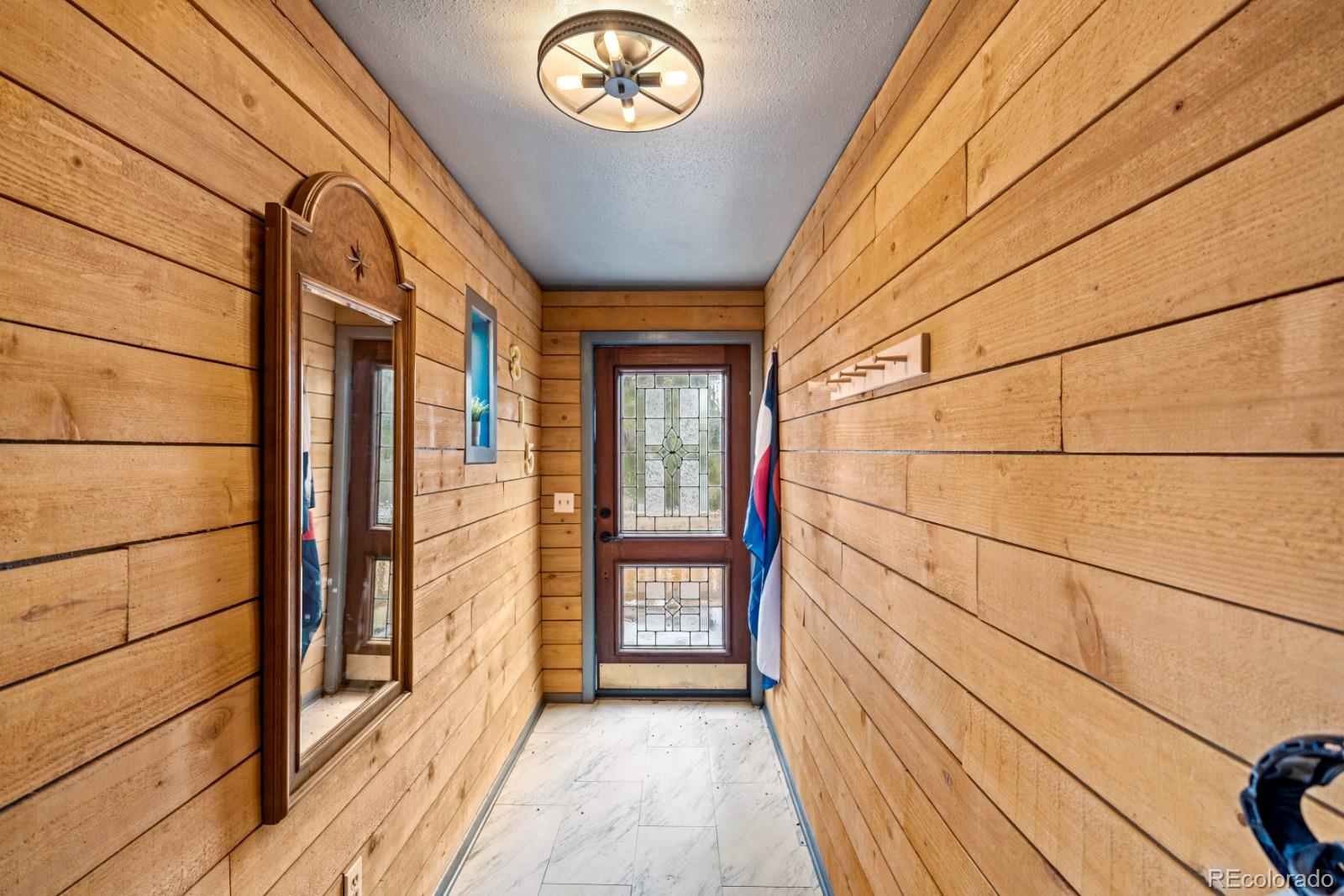 315 5th Street Victor, CO 80860 - Photo 2 of 16 a view of a hallway with wooden floor and a window