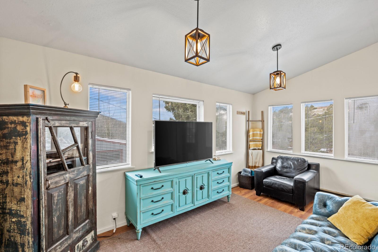 315 5th Street Victor, CO 80860 - Photo 5 of 16 a living room with furniture and a flat screen tv