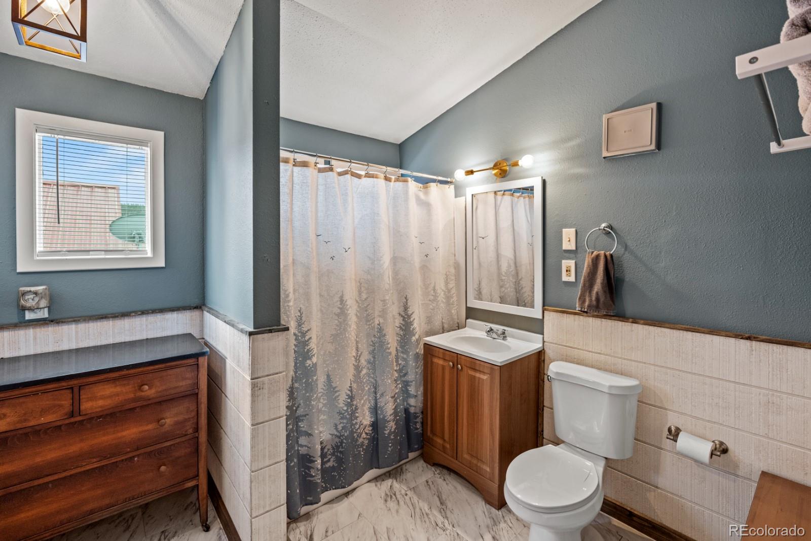 315 5th Street Victor, CO 80860 - Photo 7 of 16 a bathroom with a toilet a sink and bathtub