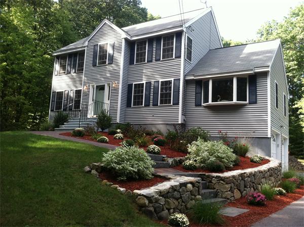 49 Chestnut Road Tyngsborough, MA 01879 - Photo 1 of 24 a front view of a house with a yard