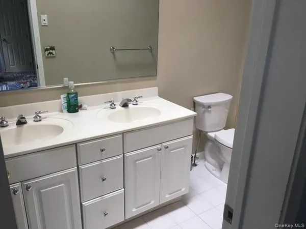 a bathroom with a sink toilet and mirror