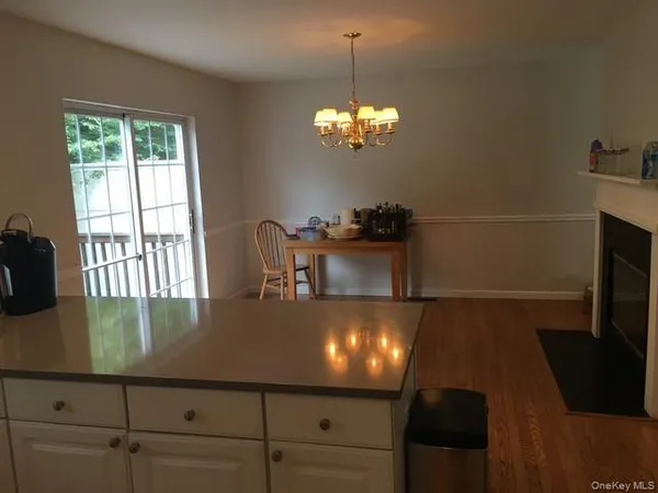 a view of a dining room with furniture and chandelier
