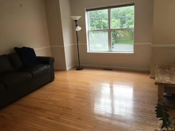 a living room with furniture window and wooden floor