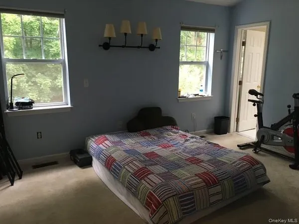 a bedroom with a bed and window