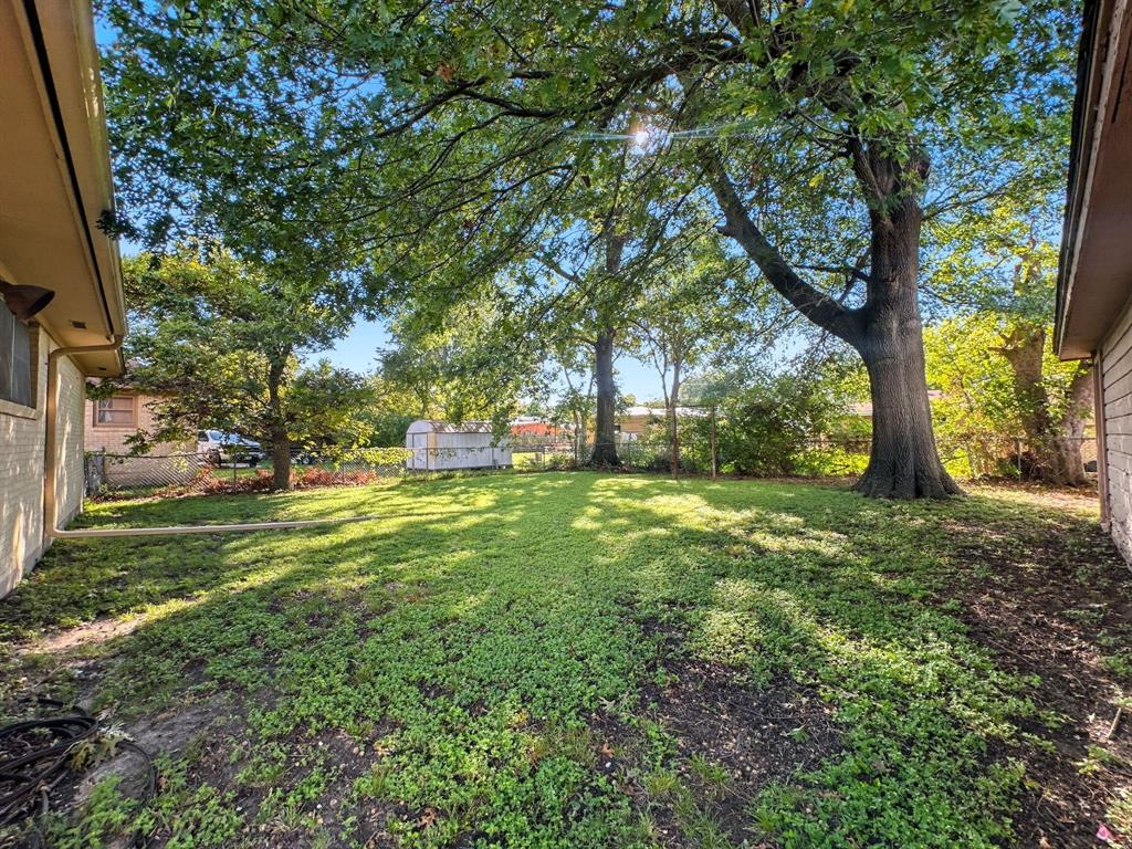 817 South Rusk Street Gainesville, TX 76240 - Photo 24 of 25 a view of a trees with a yard