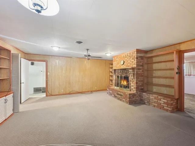 an empty room with a empty space and windows