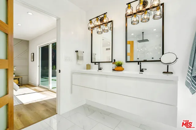a view of a chair and table in backyard of the house