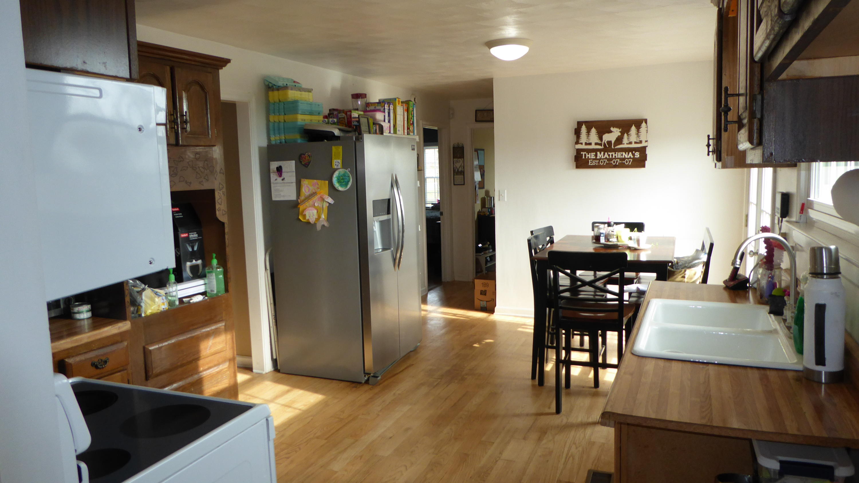 280 Rock Ridge Road Callaway, VA 24067 - Photo 22 of 37 a kitchen with stainless steel appliances granite countertop a refrigerator a stove a dining table and chairs with wooden floor