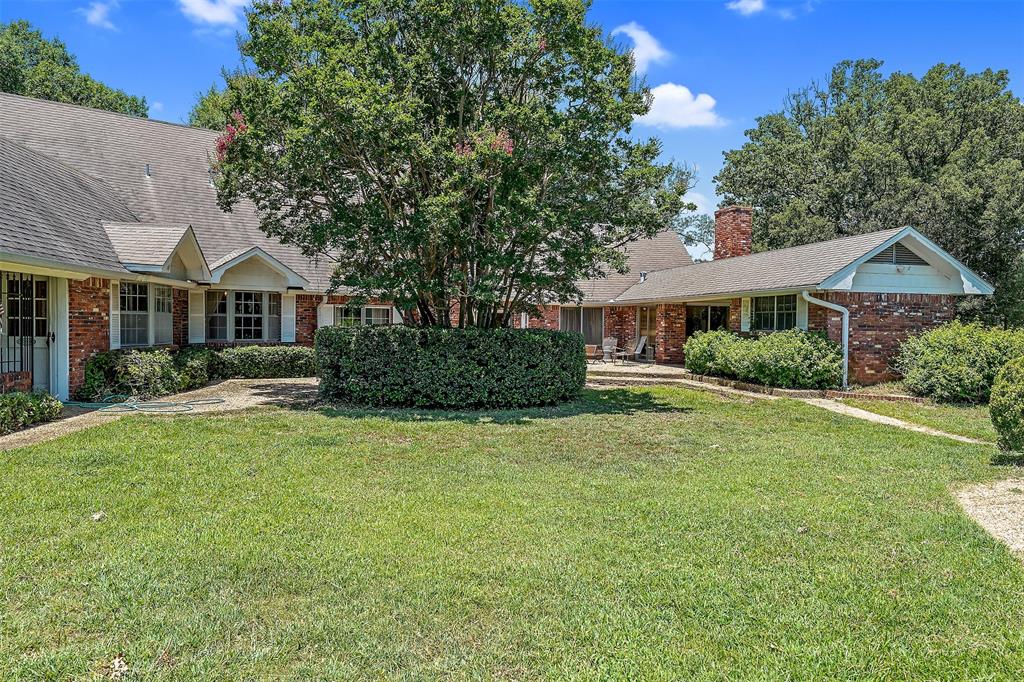 100 Inwood Street Mineola, TX 75773 - Photo 14 of 31 a front view of a house with a yard
