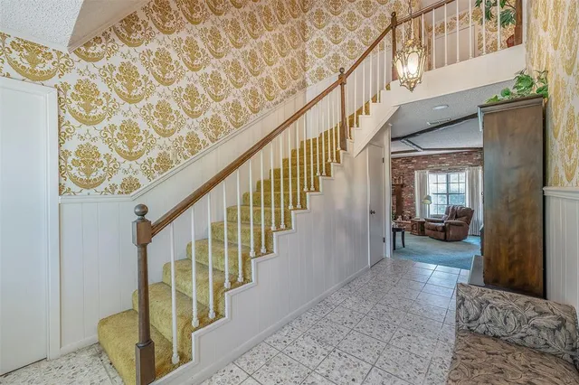 a view of staircase with wooden floor and a rug