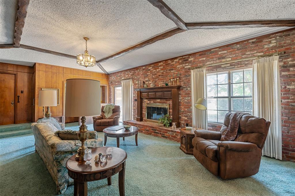 100 Inwood Street Mineola, TX 75773 - Photo 16 of 31 a living room with furniture a chandelier and a large window
