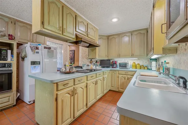 a kitchen with stainless steel appliances granite countertop a sink and cabinets