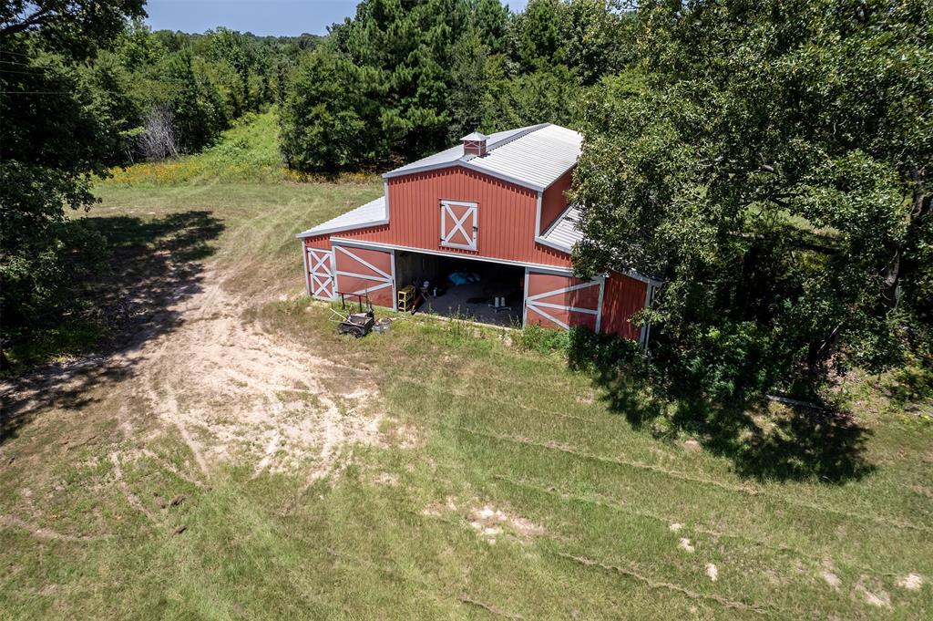 100 Inwood Street Mineola, TX 75773 - Photo 2 of 31 a sign board with tall trees