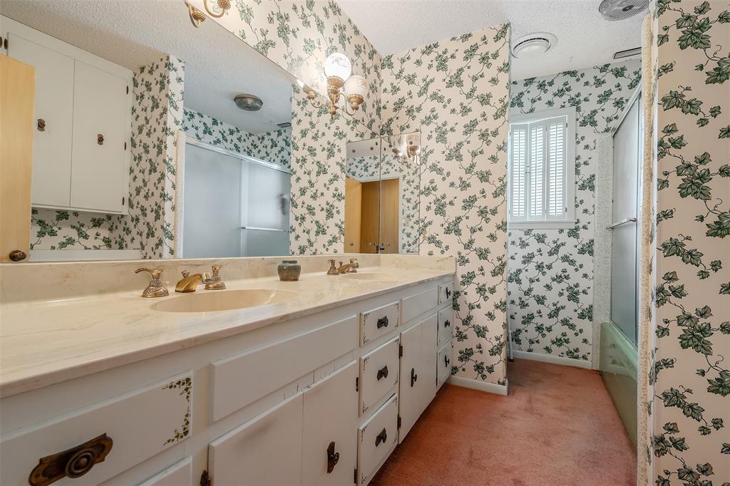100 Inwood Street Mineola, TX 75773 - Photo 26 of 31 a spacious bathroom with double vanity and a mirror