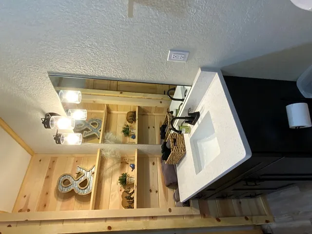 a spacious bedroom with a bed and a flat screen tv