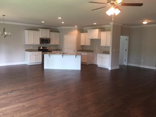 590 Las Roblas Grande Drive Santa Rosa Beach, FL 32459 - Photo 14 of 20 a view of kitchen with refrigerator stove and wooden floor