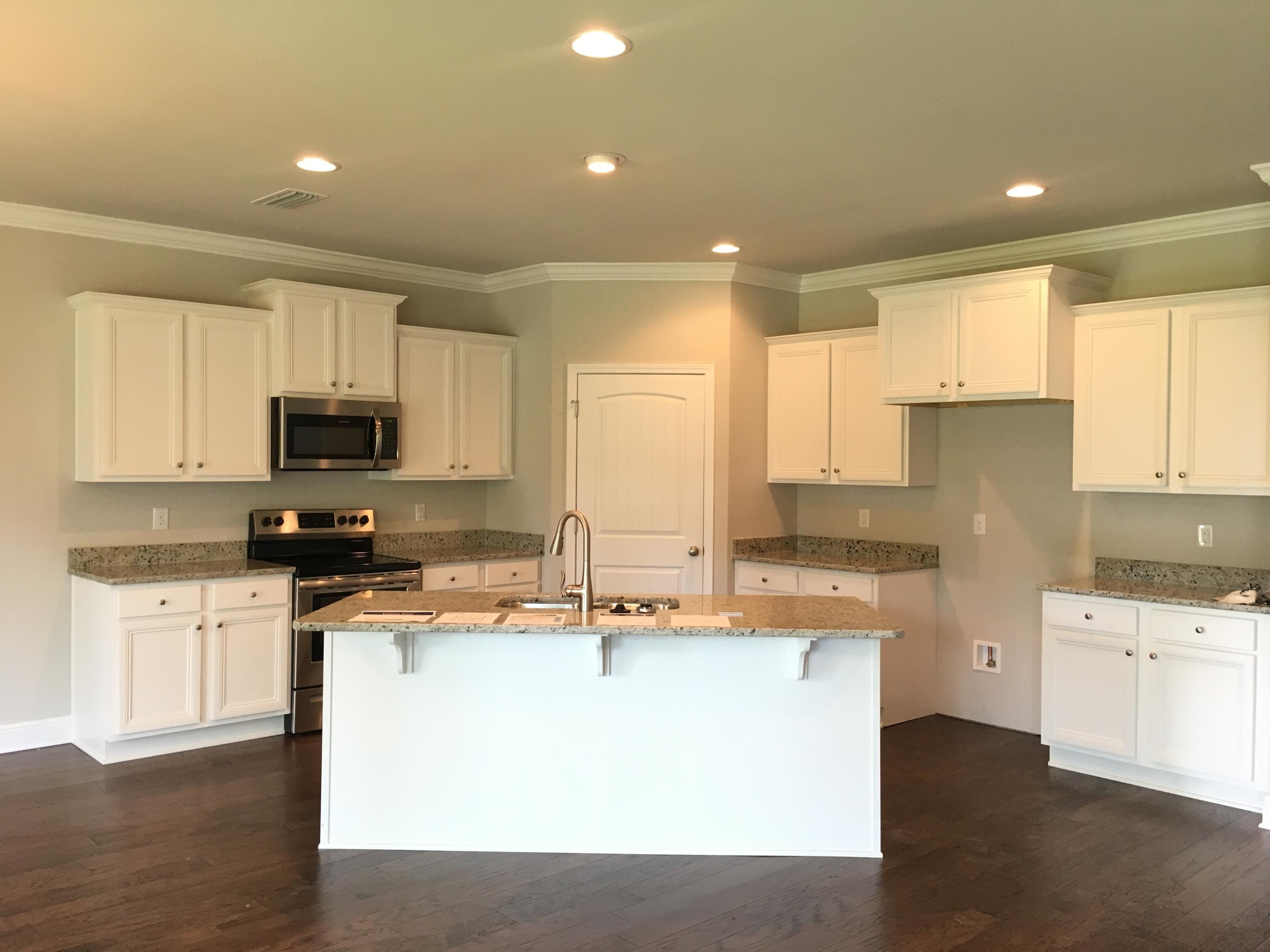 590 Las Roblas Grande Drive Santa Rosa Beach, FL 32459 - Photo 15 of 20 a kitchen with stainless steel appliances granite countertop a sink a stove a refrigerator and white cabinets