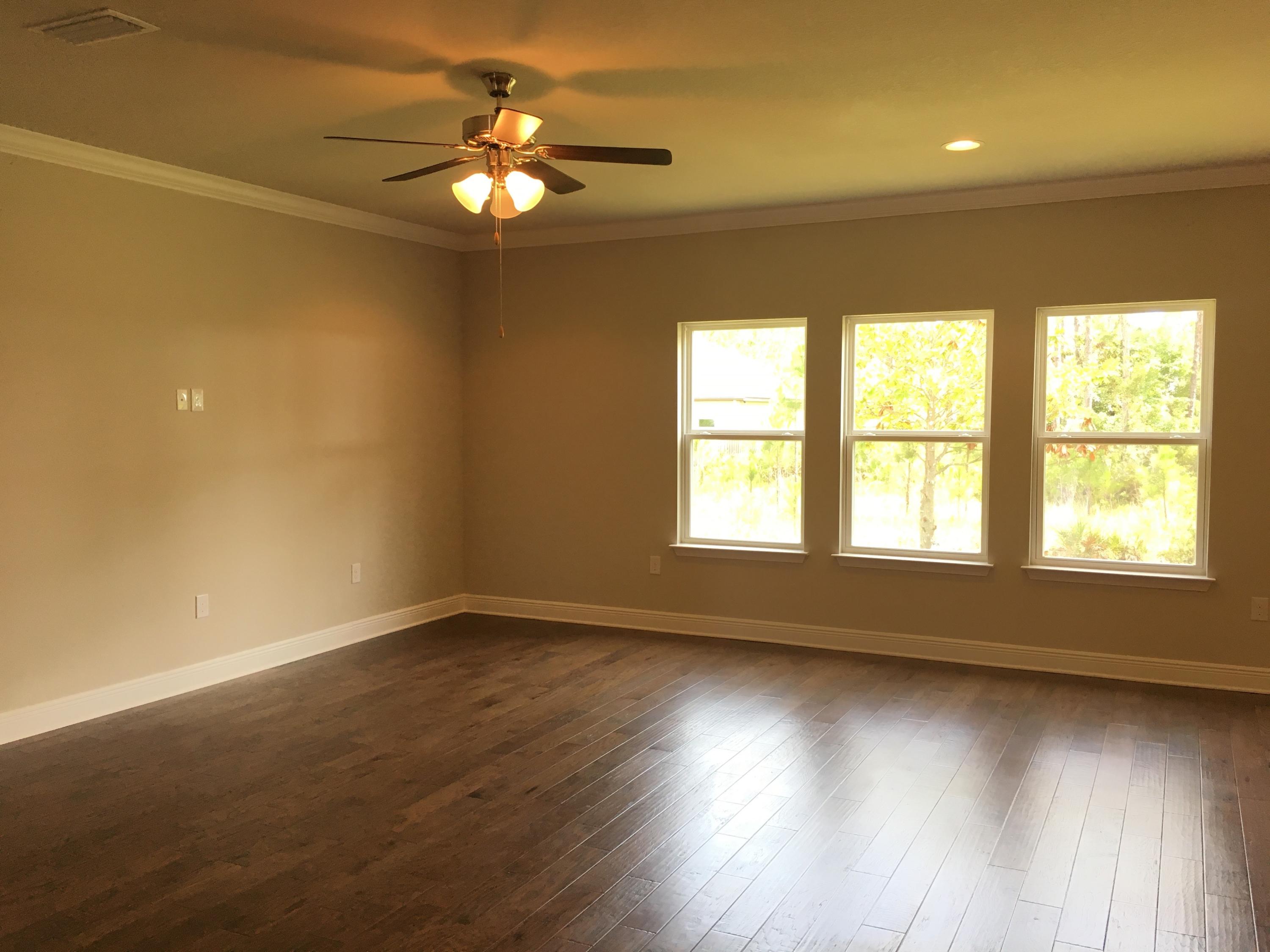 590 Las Roblas Grande Drive Santa Rosa Beach, FL 32459 - Photo 10 of 20 an empty room with wooden floor and windows