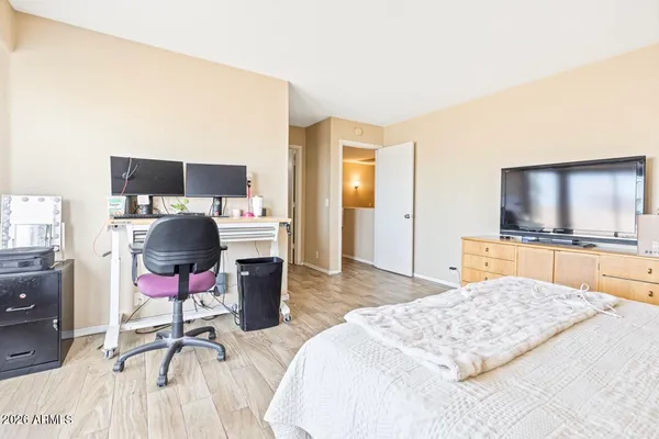 a bedroom with a bed and a large window