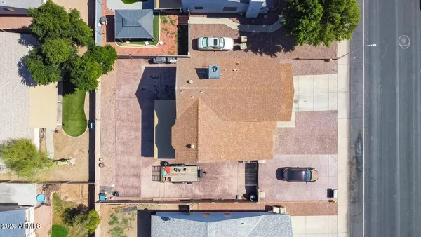 an aerial view of multiple houses with a yard