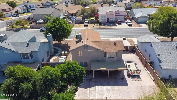 an aerial view of residential houses with outdoor space