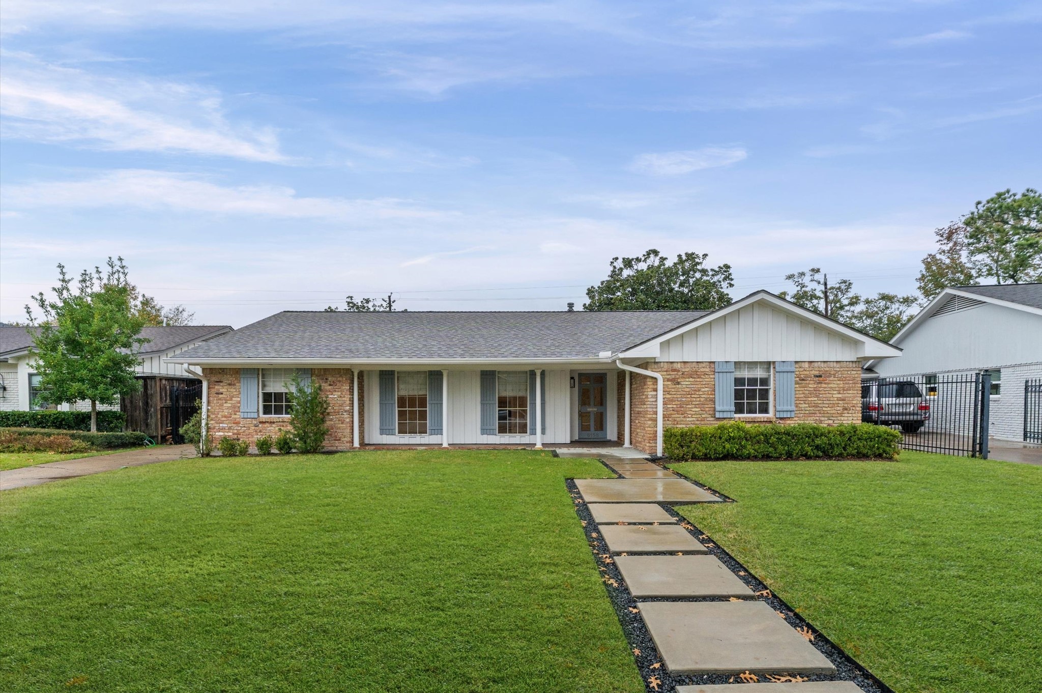 a front view of a house with a garden