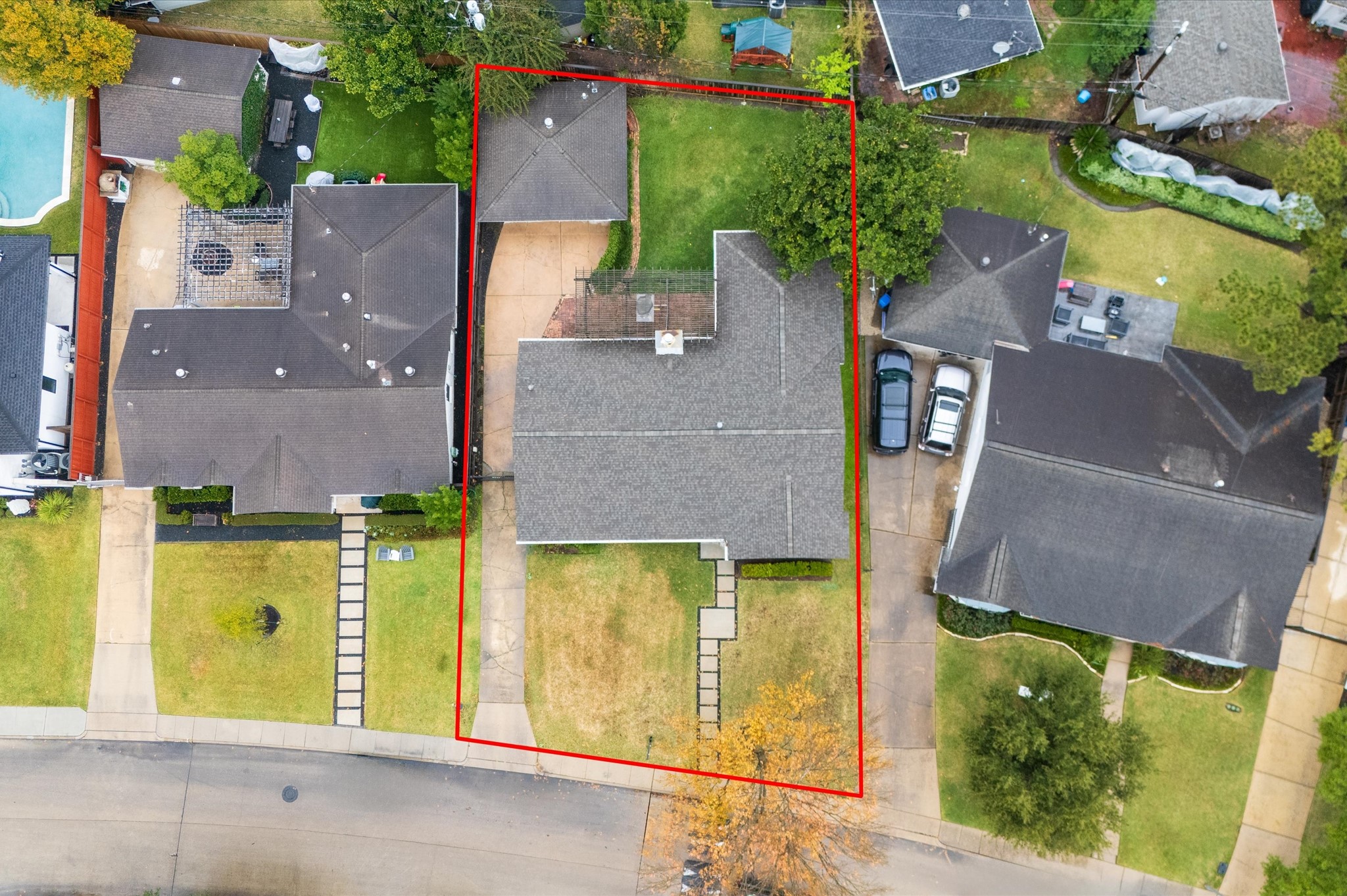 6158 Burgoyne Road Houston, TX 77057 - Photo 34 of 39 This aerial photo shows a single-story home with a large backyard, marked by a red boundary line. The property features a spacious driveway and is situated in a suburban neighborhood with neighboring houses.