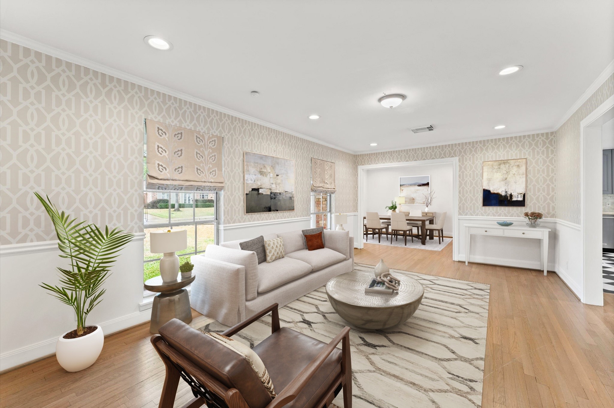 6158 Burgoyne Road Houston, TX 77057 - Photo 4 of 39 Bright, open living space with wood floors, a fireplace, and large windows. French doors lead to a patio, and there's an adjacent room with patterned wallpaper, ideal for dining. "Virtual Staging"