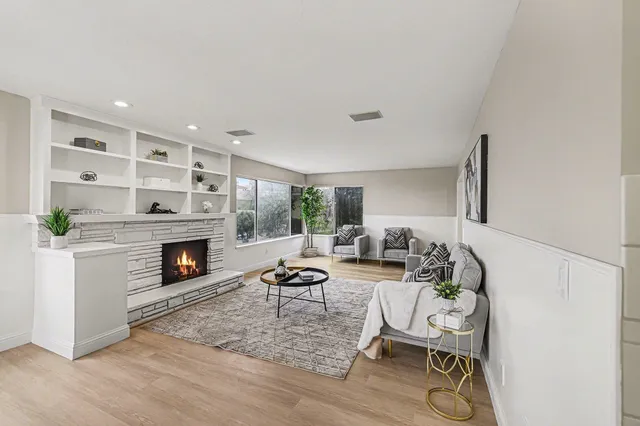a living room with furniture and a fireplace