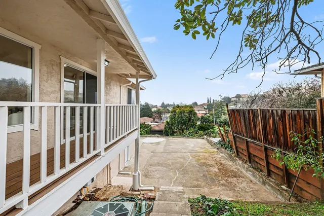 a view of a house with wooden fence