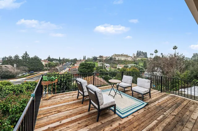 a view of a roof deck with furniture