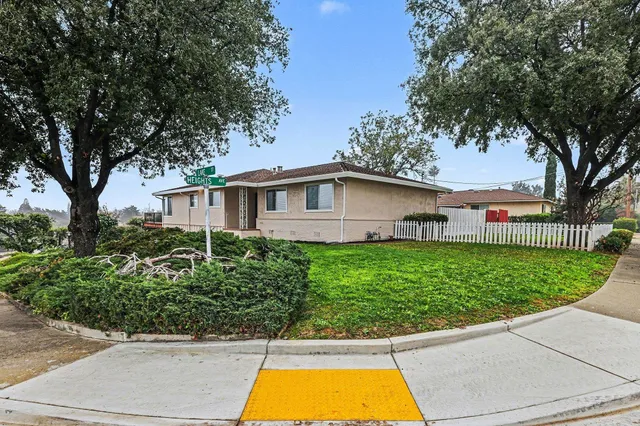 a view of a house with a swimming pool and a yard