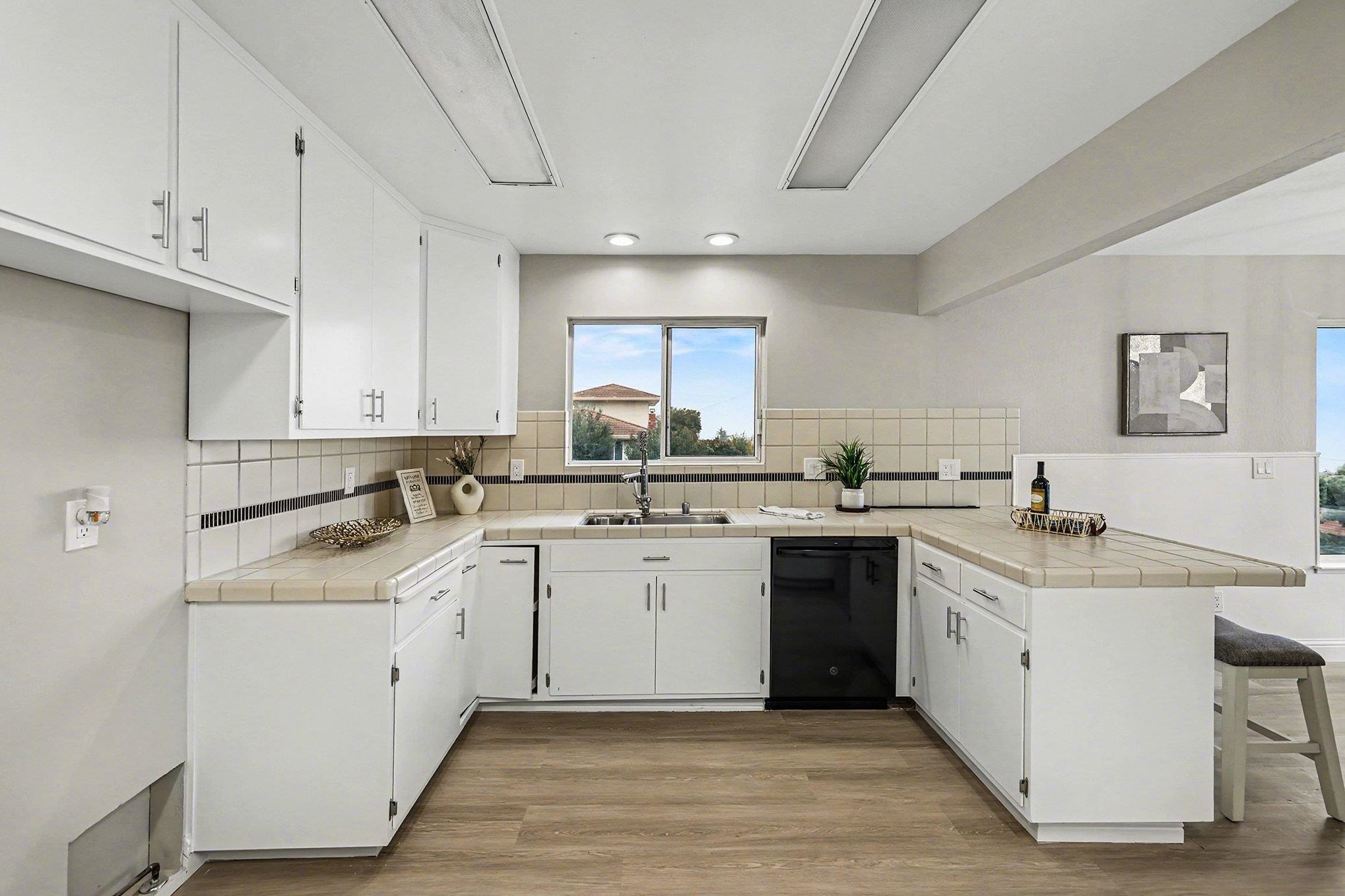 6 Lake Street Pittsburg, CA 94565 - Photo 8 of 29 a kitchen with a sink white cabinets and white appliances