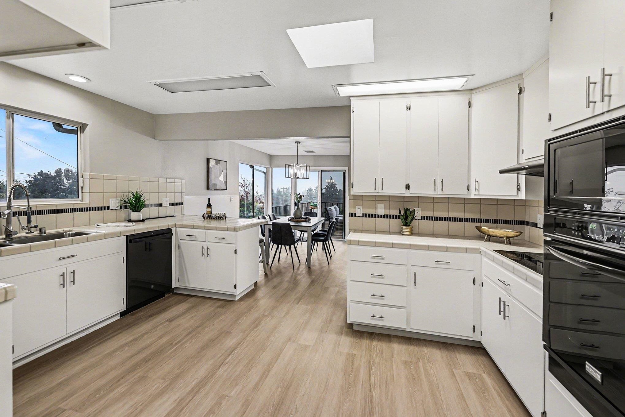 6 Lake Street Pittsburg, CA 94565 - Photo 9 of 29 a kitchen with white cabinets sink and white appliances