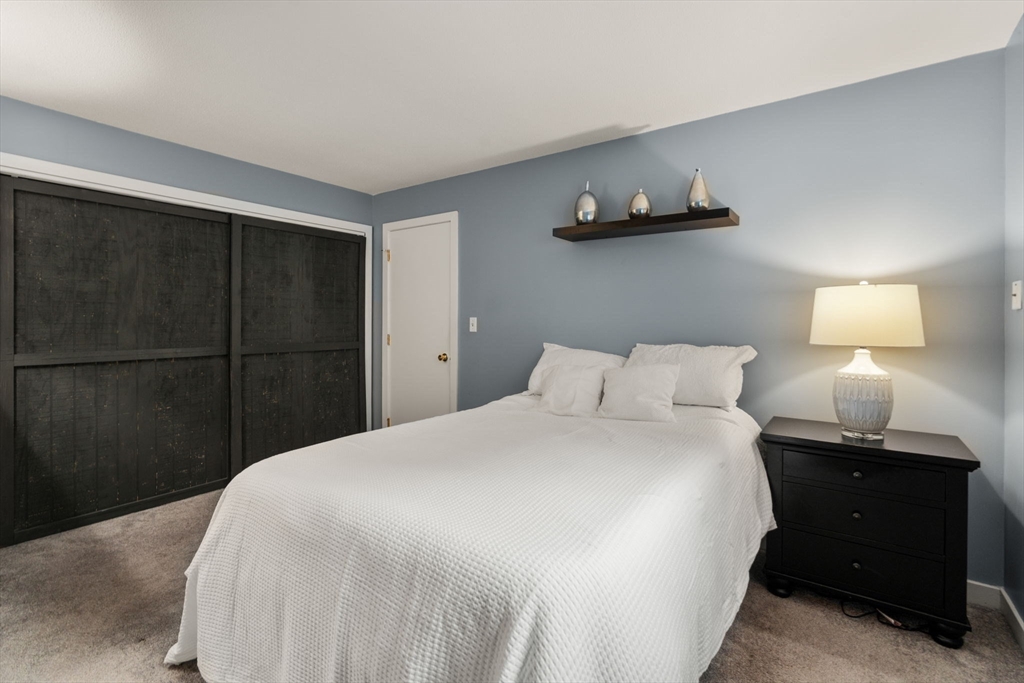 509 Dongary Road, Unit 509 Easton, MA 02375 - Photo 19 of 29 a bedroom with a bed and a lamp