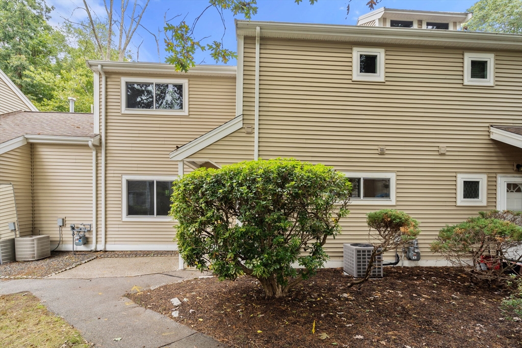 509 Dongary Road, Unit 509 Easton, MA 02375 - Photo 23 of 29 a view of a house with a yard and a chair