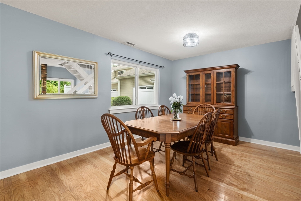509 Dongary Road, Unit 509 Easton, MA 02375 - Photo 6 of 29 a view of a dining room with furniture and wooden floor