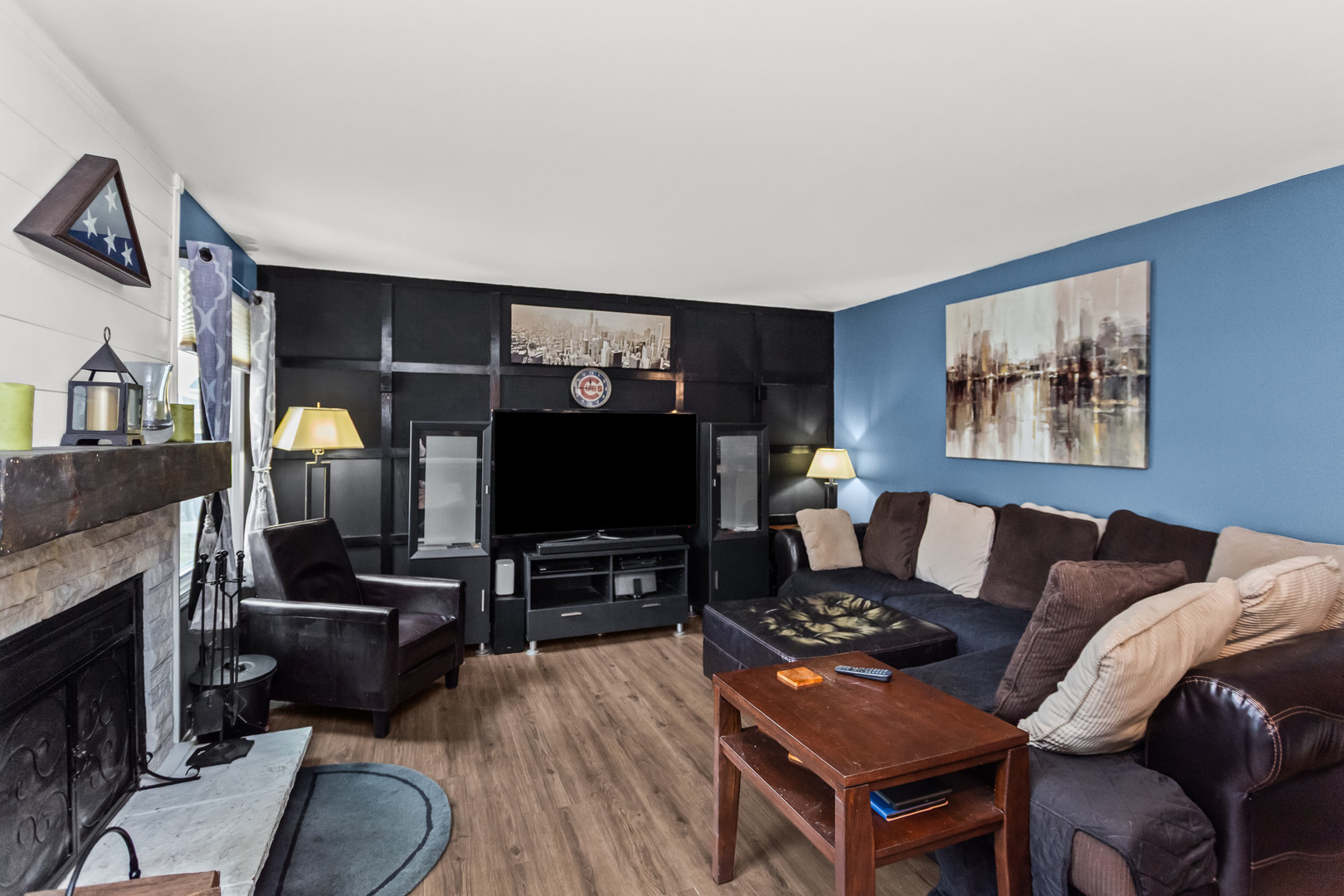 960 Mensching Road Roselle, IL 60172 - Photo 11 of 25 a living room with furniture a flat screen tv and a fireplace