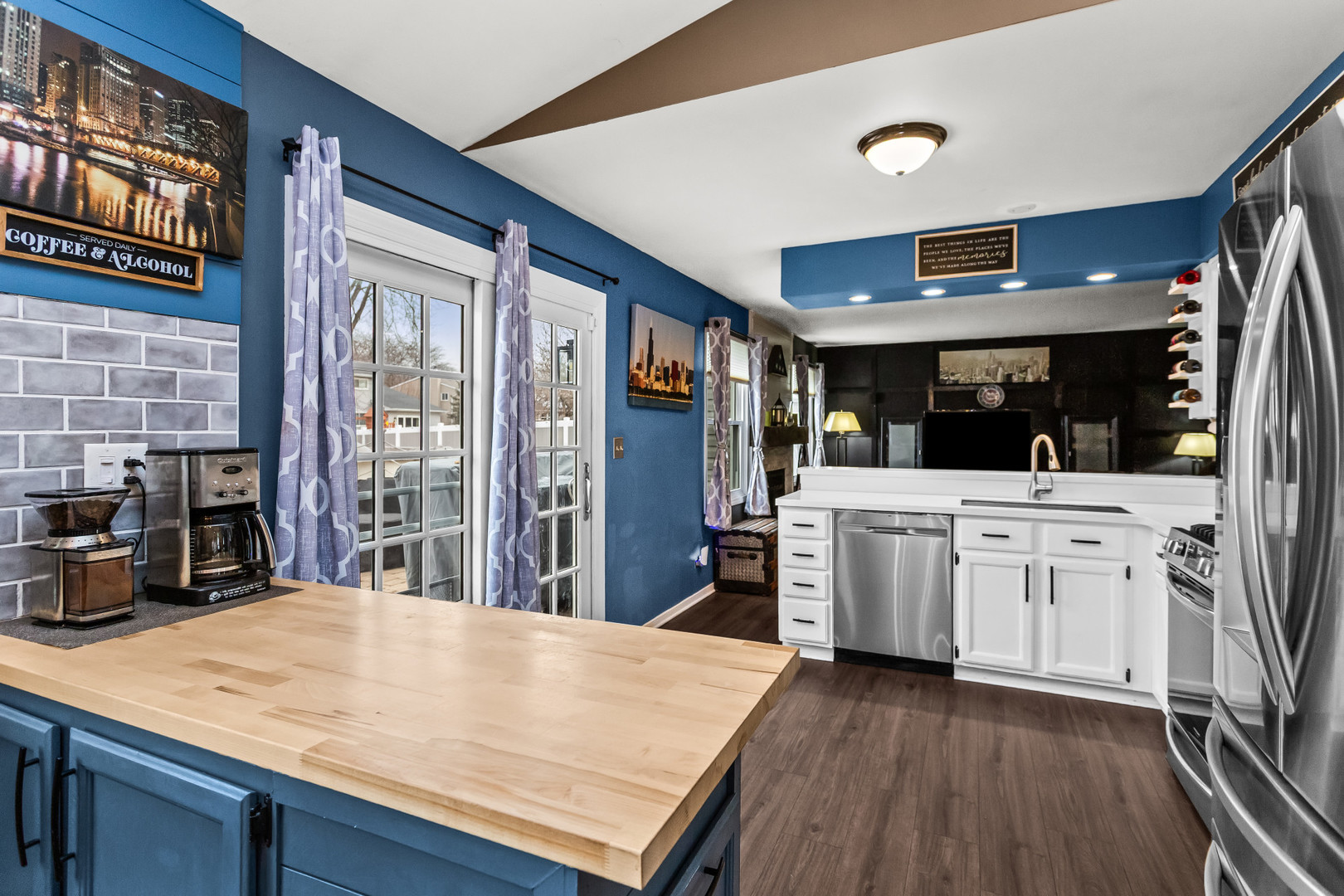 960 Mensching Road Roselle, IL 60172 - Photo 7 of 25 a kitchen with stainless steel appliances kitchen island wooden floors and refrigerator
