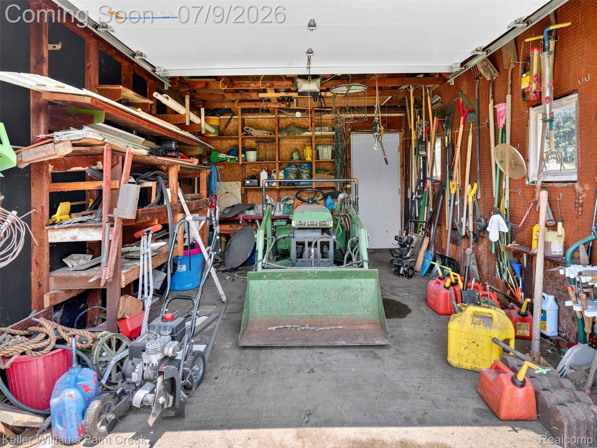204 Russell Road Kawkawlin, MI 48631 - Photo 54 of 82 Interior garage with concrete flooring, exposed wood framing, and built-in shelving