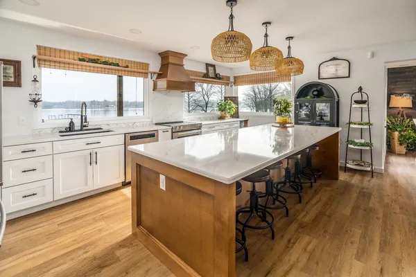a kitchen with granite countertop white cabinets and white appliances