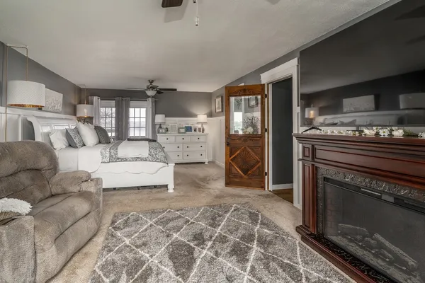 a bedroom with a bed couch and window