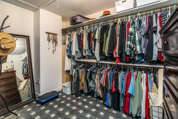 a spacious bedroom with two beds and a flat screen tv