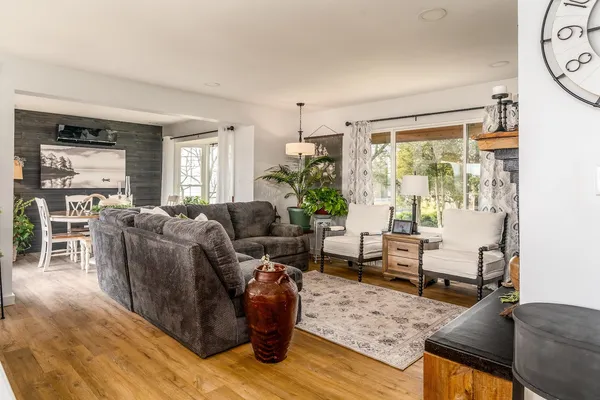 a living room with furniture and wooden floor