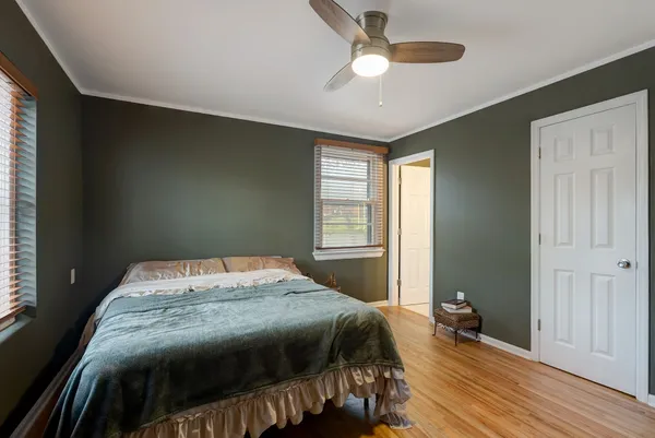 a bedroom with a bed and a window