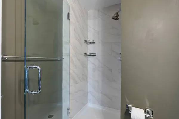 a bathroom with a glass shower door