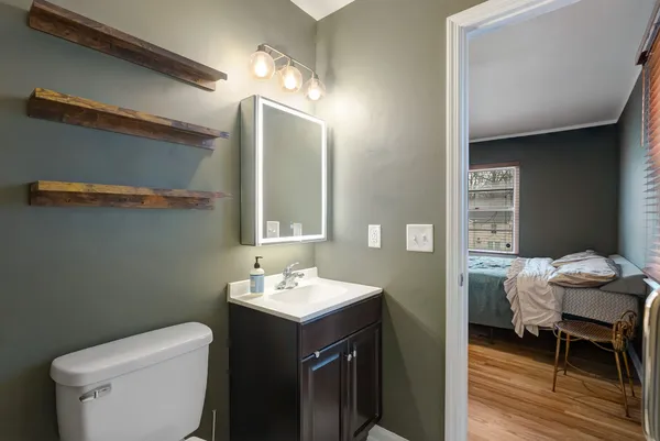 a bathroom with a toilet sink and mirror