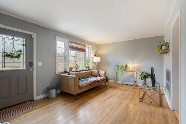 a living room with furniture and a wooden floor